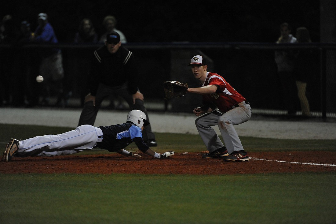 An Out-of-Door Academy base runner races to first base. Photos Courtesy of Tom Hubbard.
