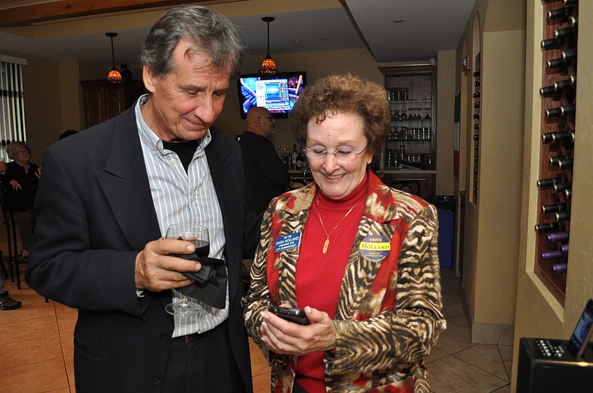 Linda Holland waits for results on her cell phone with fellow city of Sarasota Nuisance Abatement board member Fernando Gobic.