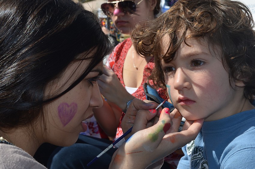 Pine View sophomore Nicole Kassicieh paints four-year-old Zackary Manooshianâ€™s face.