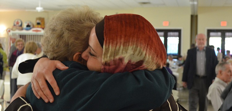 Nasareen Sawaf and Pat Dever met each other at the Feast of Abraham 10 years ago and have stayed friends since. They embrace each other after not seeing each other in a long time.