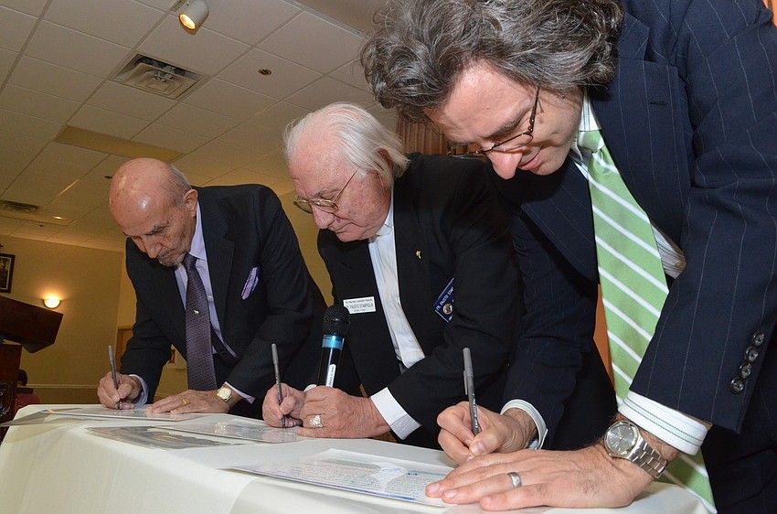 Hassan Hammami of the Islamic Community of Southwest Florida, Father Fausto Stampiglia of St. Marthaâ€™s Catholic Church and Rabbi Brenner Glickman of Temple Emanu â€“ El sign faith certificates.