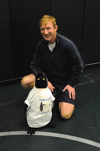 Throughout his journey, coach Nels Matson will be carrying his companion, Diplo the Diplomatic Penguin, on his back.