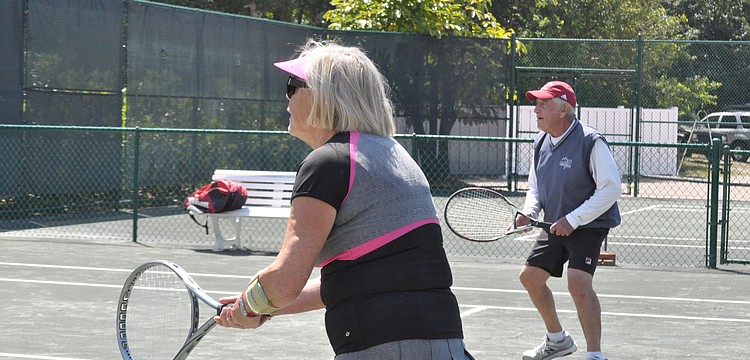 Marlies Black and Arnie Heltzer rush the net.