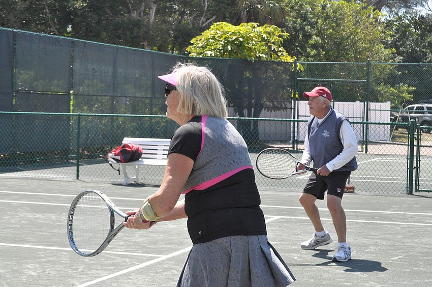 Marlies Black and Arnie Heltzer rush the net.