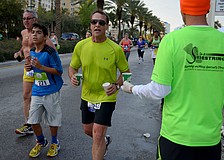 Runners stop for water near the six-mile mark.