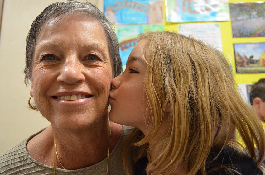 Preschooler Summer Schulz expresses her love of grandma Grace Shulz with a kiss.