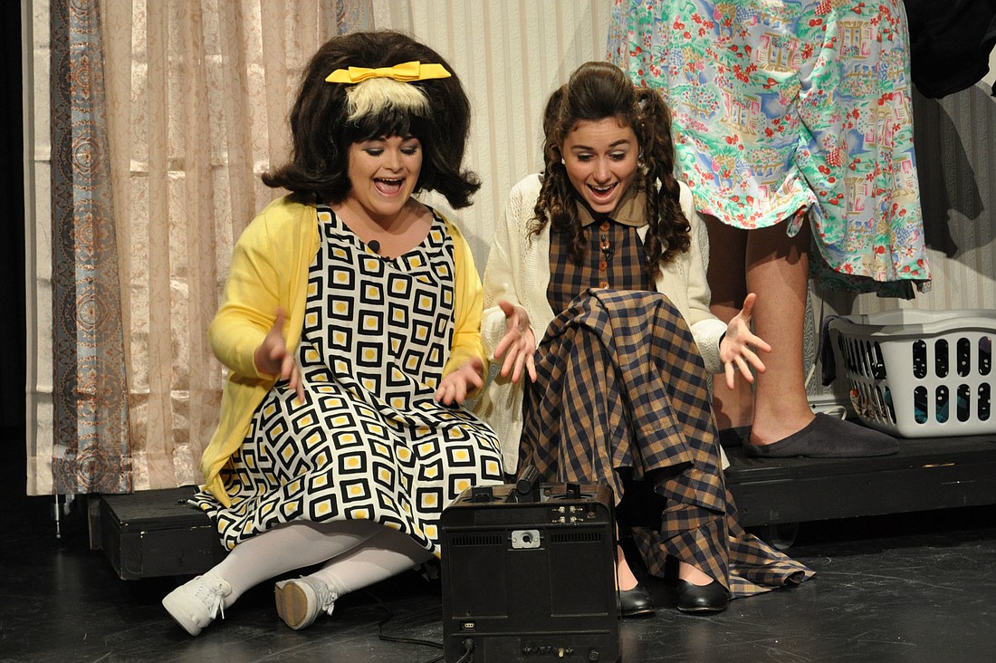 Tracy Turnblad and her best friend Penny Pingleton, played by Gabby Maraia and Julia Bellanger, watch television.