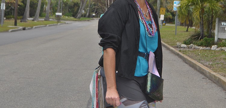 Jennifer Redding dressed as a peacock to greet shoppers as they pulled into the Village.