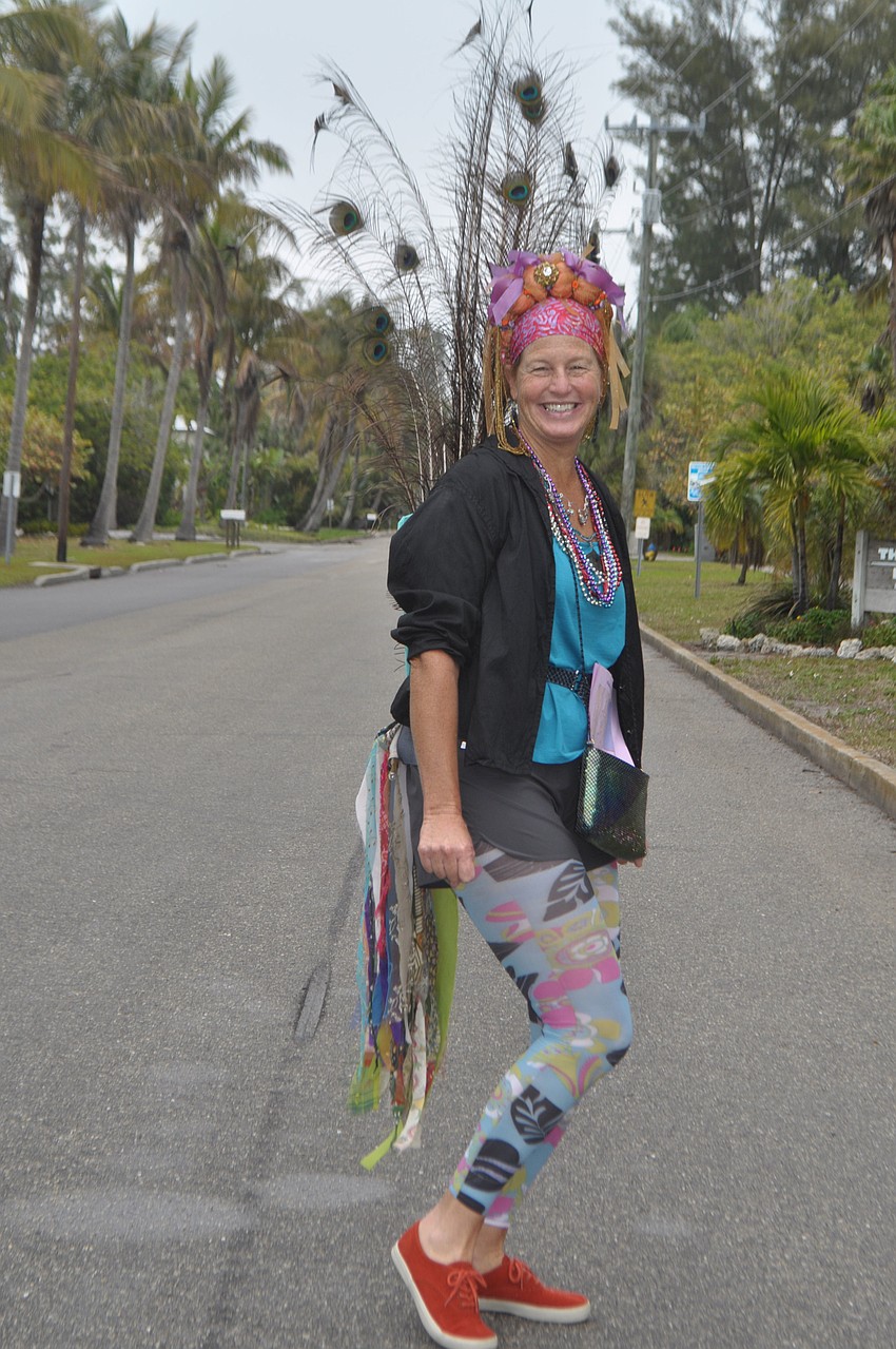 Jennifer Redding dressed as a peacock to greet shoppers as they pulled into the Village.
