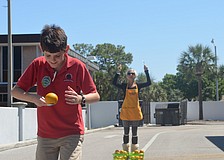 Southside Elementary fifth grader Mason Thomas runs a relay orange race with classmates at the Brownâ€™s Grove zone.