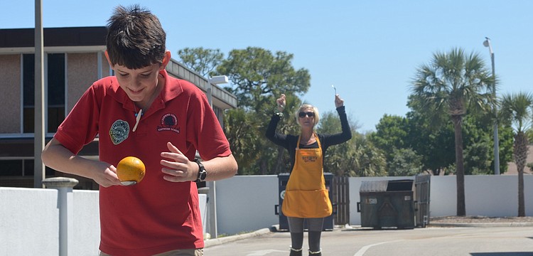 Southside Elementary fifth grader Mason Thomas runs a relay orange race with classmates at the Brownâ€™s Grove zone.