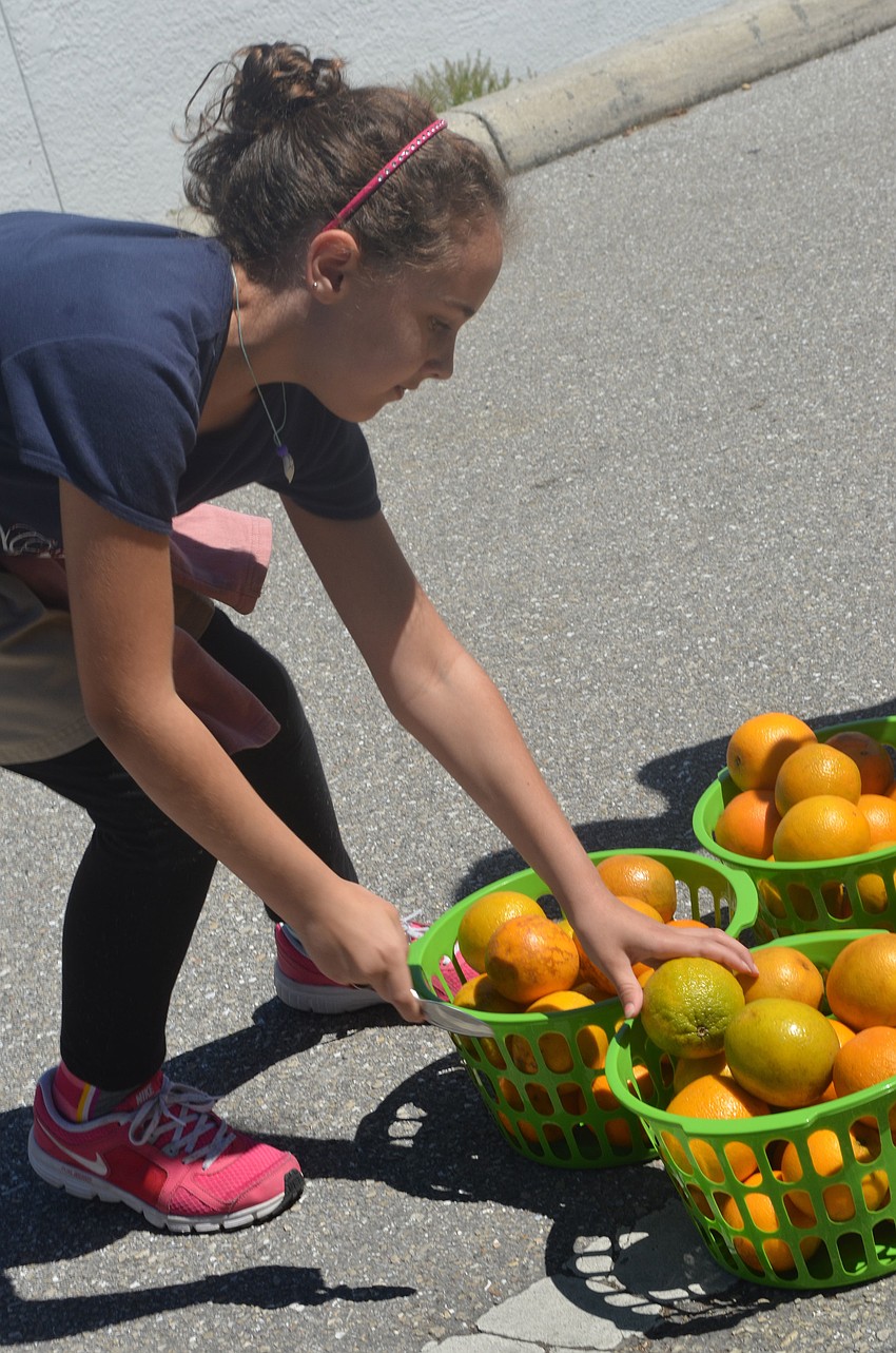 Fifth grader Katie Beal drops of an orange during the relay race at the Browns Grove Zone.