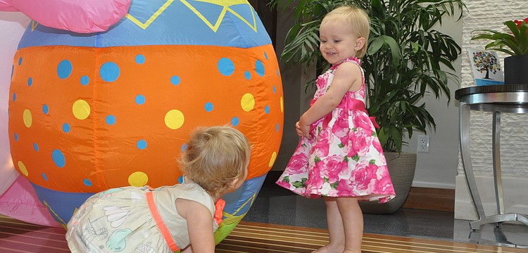 Navah Cassagnol, 1, and Brynn Haworth, 1, become new friends at the Easter party.