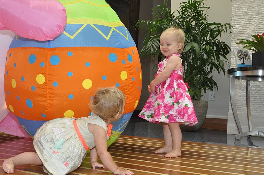 Navah Cassagnol, 1, and Brynn Haworth, 1, become new friends at the Easter party.
