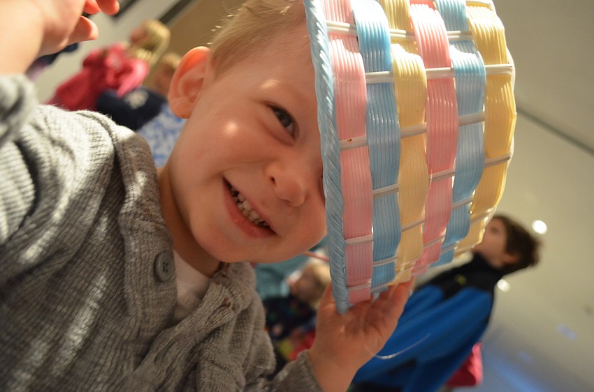 Colin Rudisell puts an Easter egg basket on his head during Granny Gooseâ€™s story time.