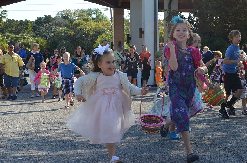 Ashleigh Morris and Ella Rochester run toward the Easter eggs.