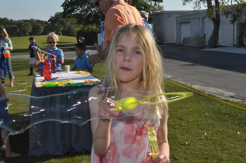 Lara King, 8, blows blubbles.