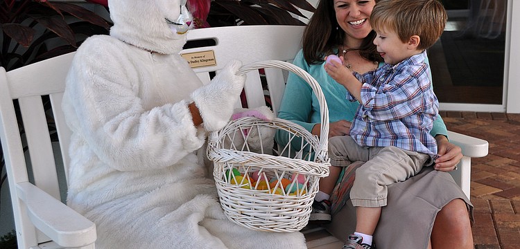 Waylon Carr, 2, shows his mom, Caroline, the Easter egg he received from the Easter Bunny.