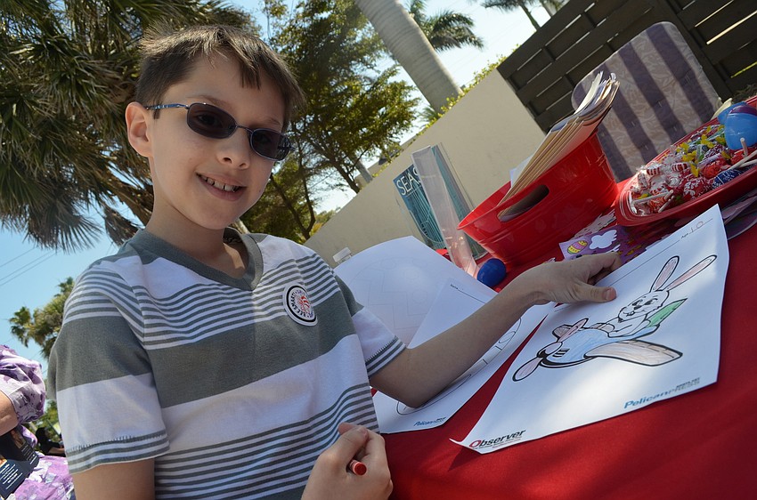 Stephen Hunt colors pictures at the Observer Media Group's activity station.