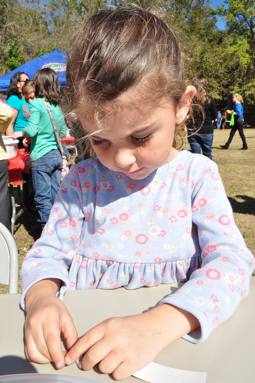 Hailee Hiscox, 5, worked intently on her bead jewelry.
