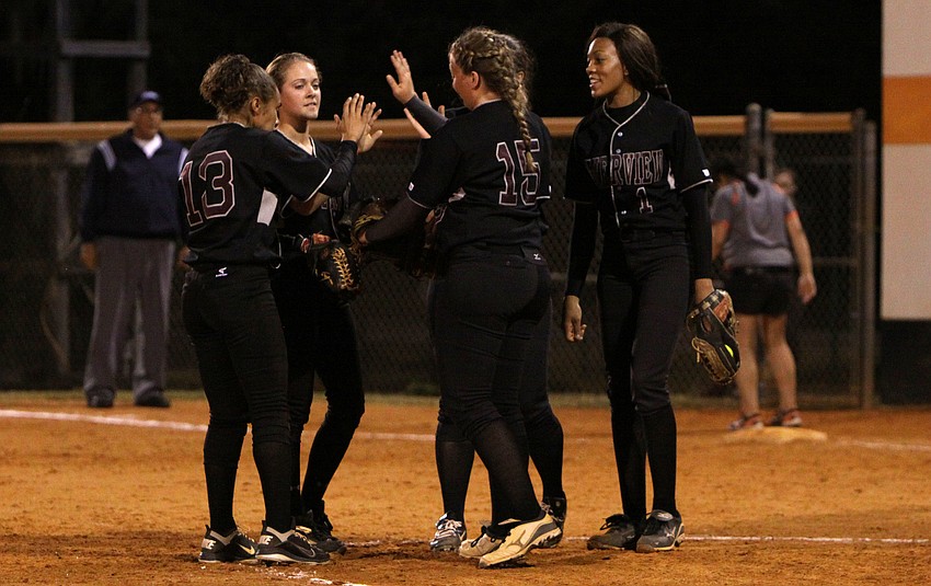 The Rams infield players meet on the mound to high-five one another after getting another player out.