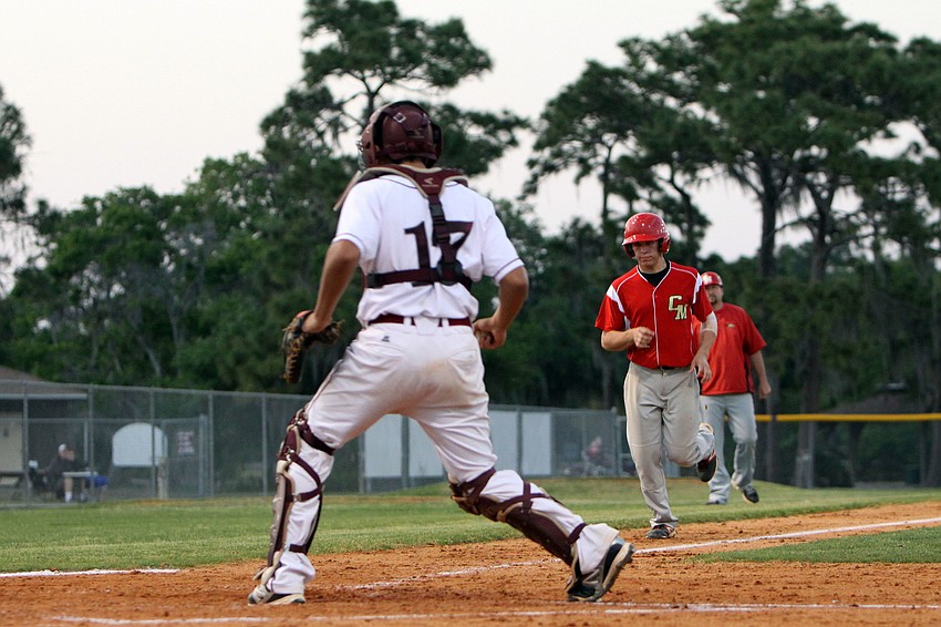 Riverviewâ€™s Nick Bisplinghoff, No. 17, runs back towards home to tag out Cardinal Mooneyâ€™s Davis Roddenberry, No. 4.