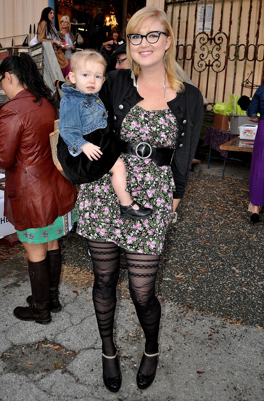 Jen Oâ€™Connor holds her daughter Penelope Daly, 15-mos., who was the model for the eventâ€™s poster.