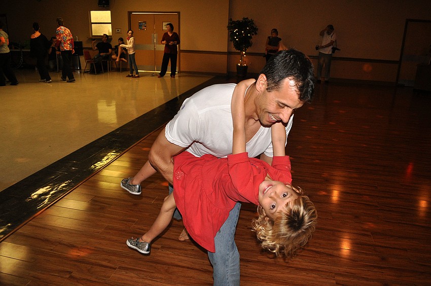 Eric Tate dips his daughter, Isabella, 4.