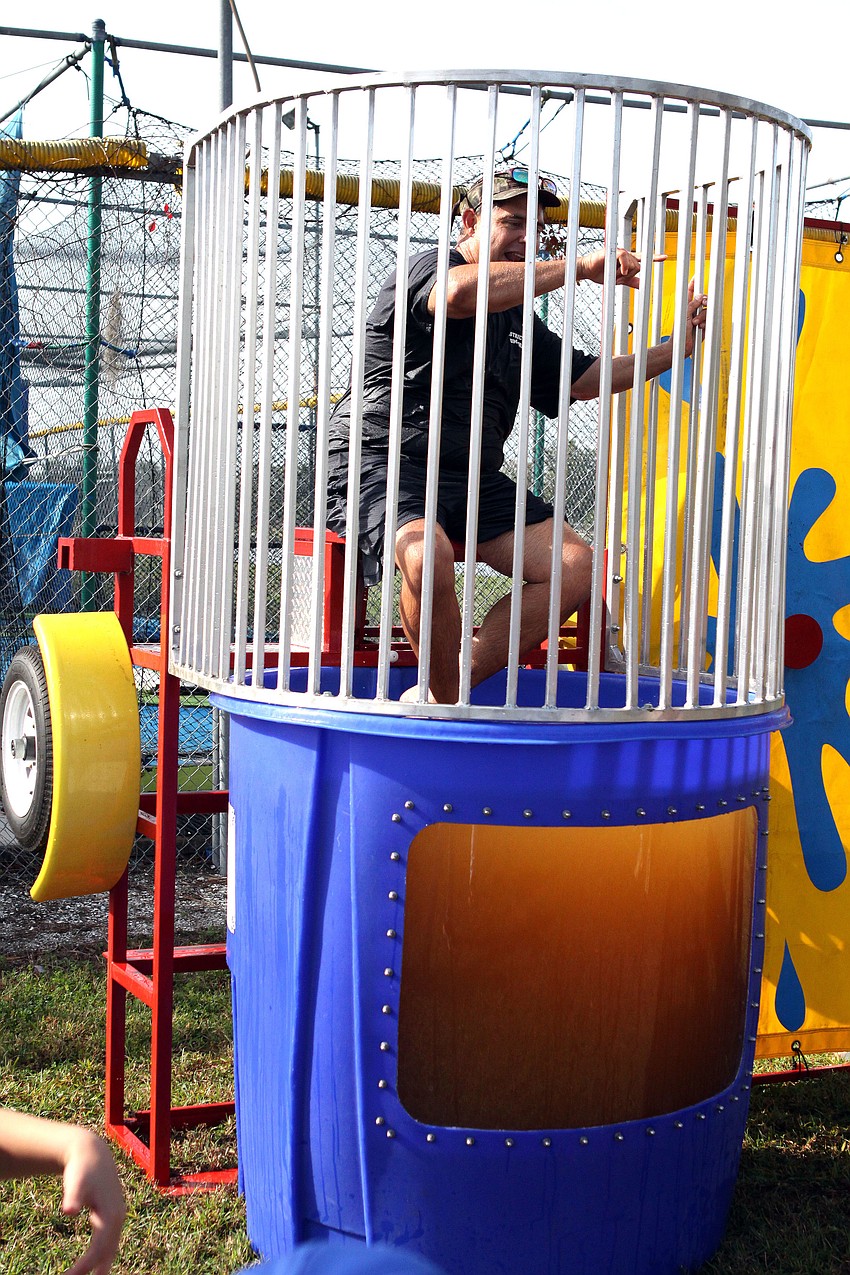 Neil Bain tries to get a rise out of the kids while sitting in the dunk tank Saturday, Feb. 16, during Sarasota Little Leagueâ€™s opening day.