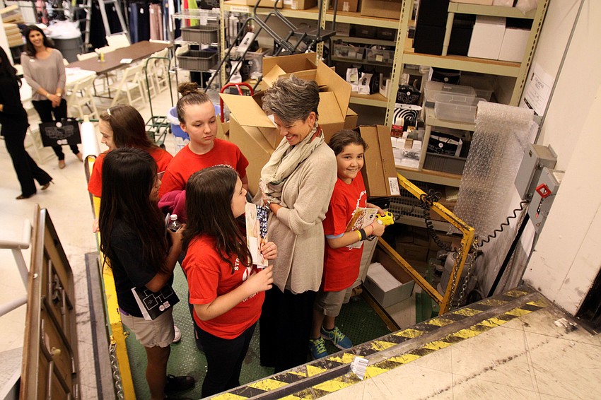 Sally Schule, marketing director, rides the lift with the girls.