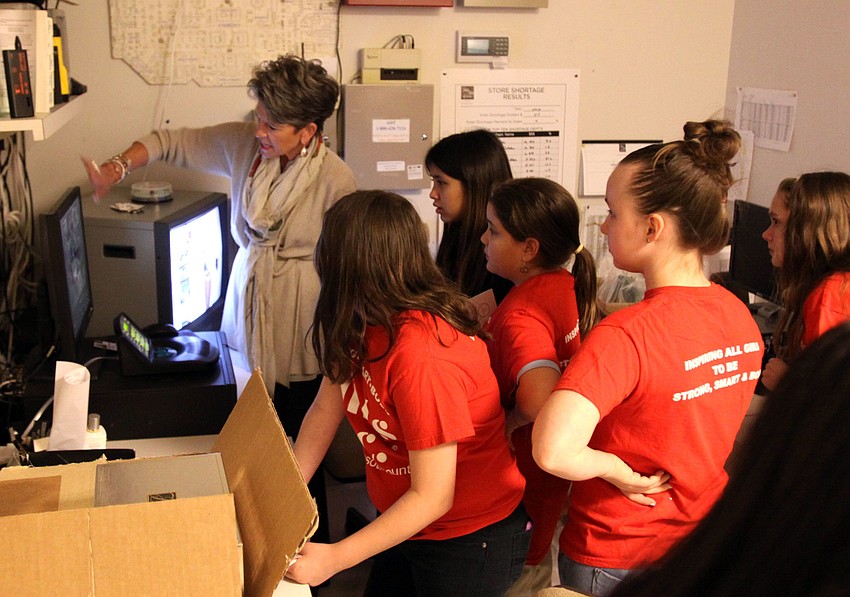 Sally Schule shows the girls the room where they watch the security cameras that are set up throughout Saks Fifth Avenue.