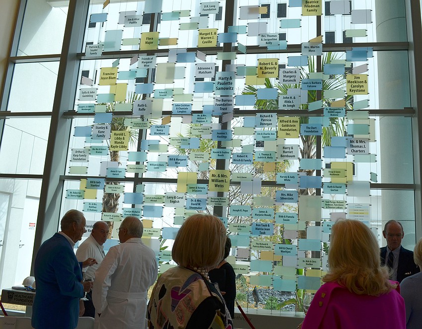 Guests admire the donor wall.