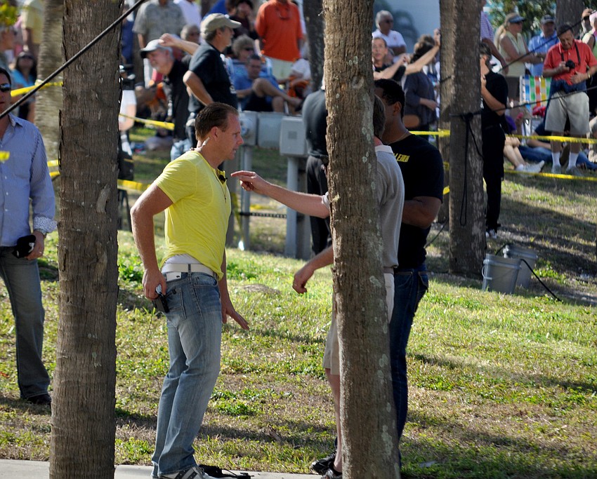 Wallenda consults crewmembers before ascending the crane.