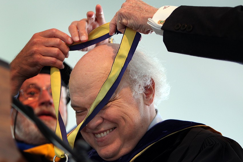 Dr. Donal Oâ€™Shea smiles as he is given the Presidential medallion.