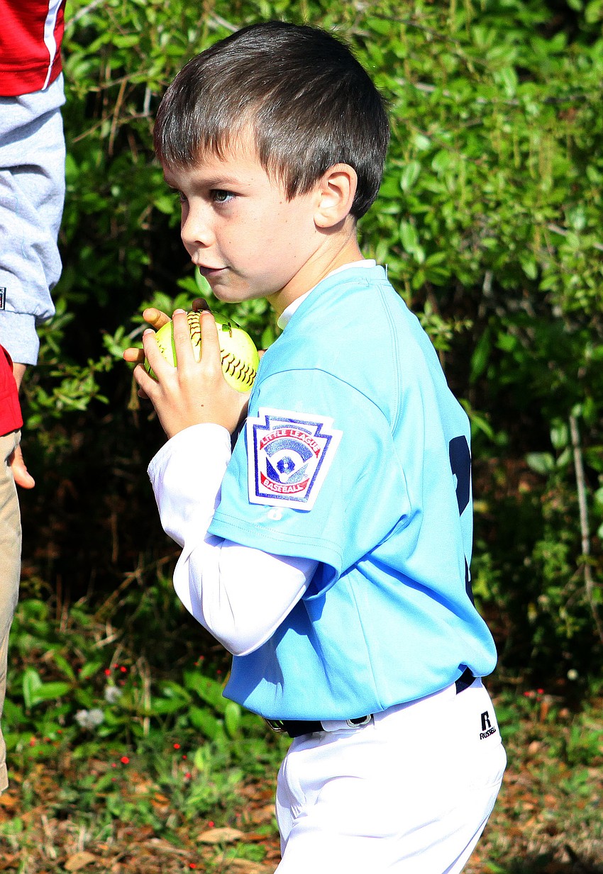 Nicholas Sparma, 7, prepares to throw the ball at the dunk tank target.