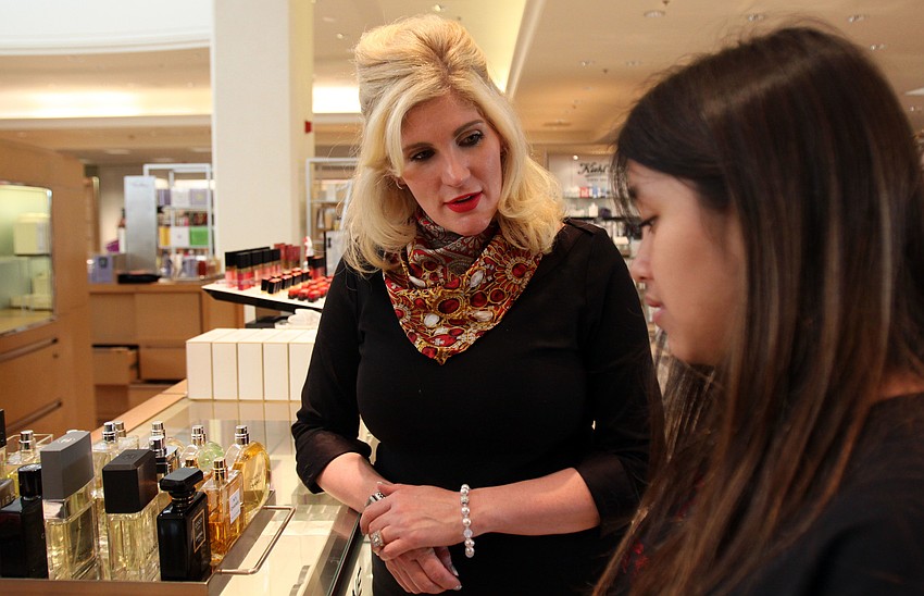 Dawn Patterson talks with Girls Inc member Erika Sanchez about Chanel perfumes.
