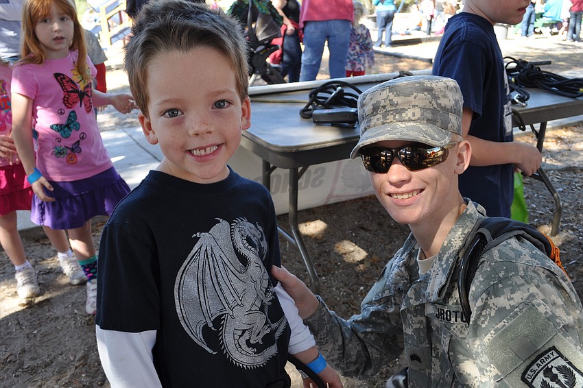 Jackson Flammang got help from Cadet Sgt. Corey Bergstrom in getting ready for a rope climbing exercise.