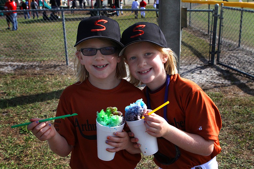 Katie and Emily Hazlett, 7, enjoy their snow cones.