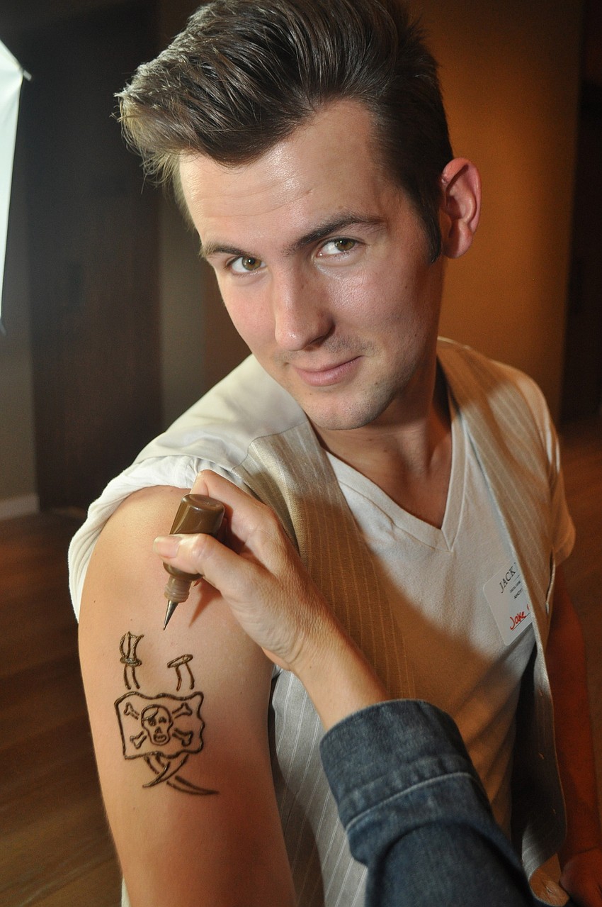 Jake Coleman gets a tattoo application from Sandy Young