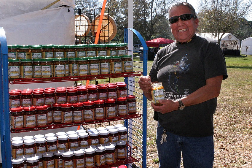 Randall Three Hawk Atcitty poses with his specialty sauces.