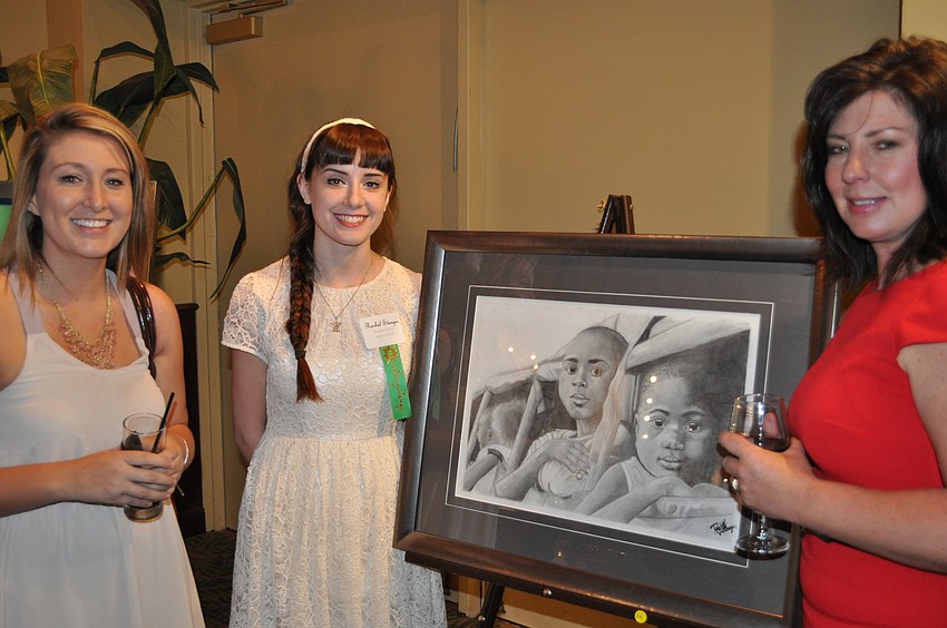 Rachel Stenner, a Braden River High School junior, showed off a drawing to Melissa and Kaileigh Prosser.