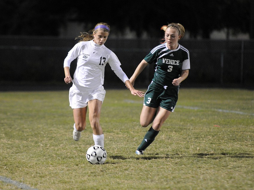Sophomore Tyler Gordon tries to fight off a Venice opponent and maintain possession in the first half.
