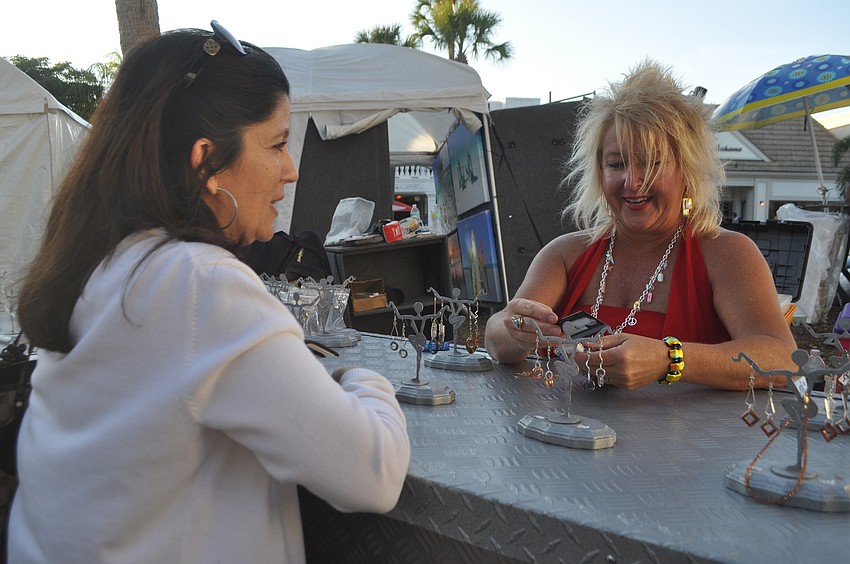 Jackie Savigne buys Swarovski crystal earrings from Christine Goshorn of Florida Fusion.