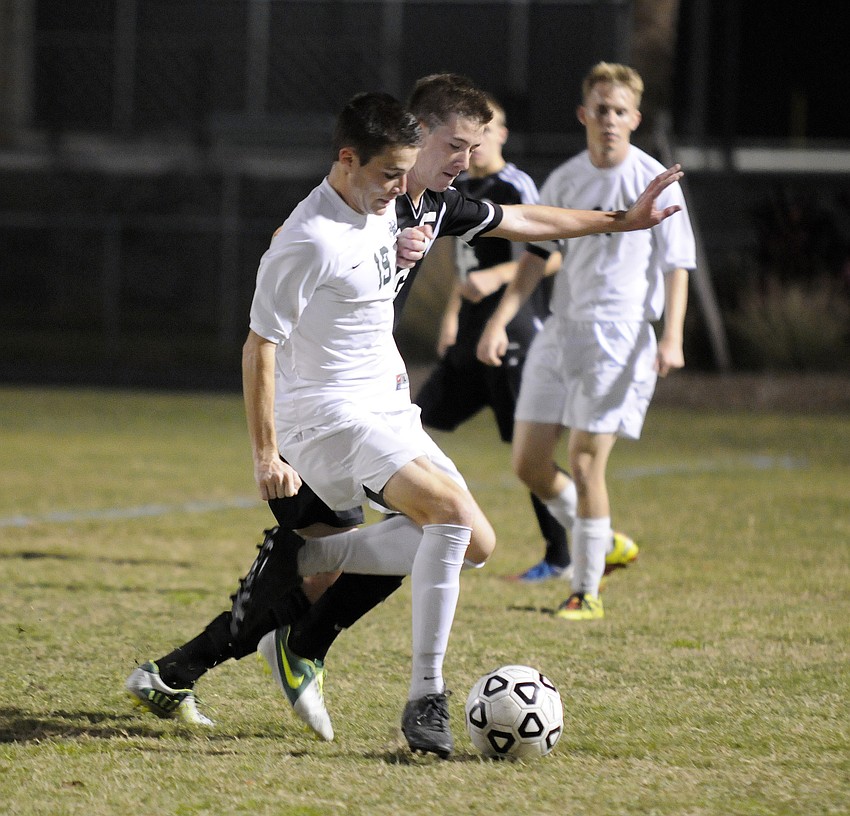 Lakewood Ranch senior midfielder Ian Nolan fights for the ball in the first half.