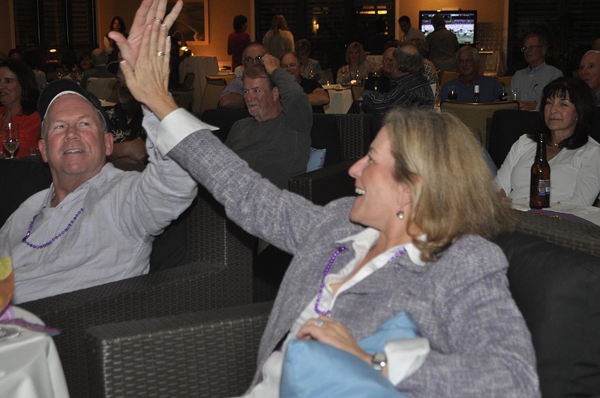 Mary and Steve Wiltse high-five after a Baltimore touchdown during the second quarter