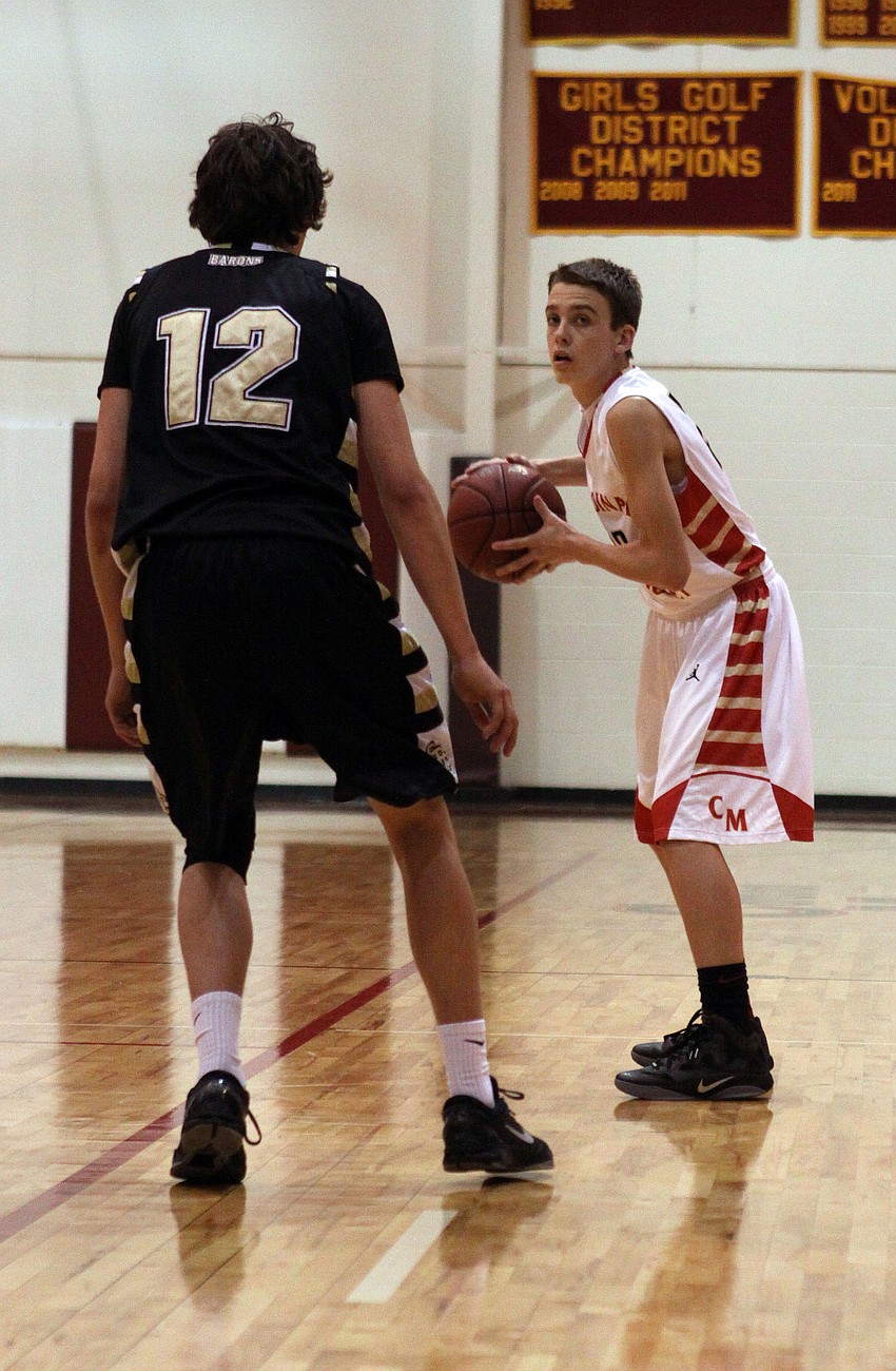 St. Petersburg Catholicâ€™s Kevin Oâ€™Donnell, No. 12, guards Cardinal Mooneyâ€™s Ryan McMahon, No. 22.
