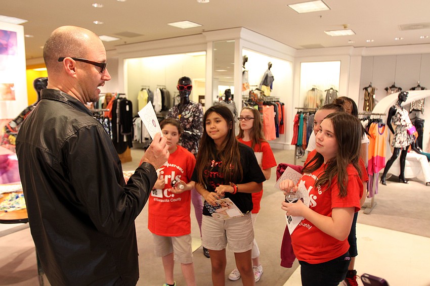 Robert Roubideaux, visual manager, talks to the girls about the displays he puts together at Saks Fifth Avenue at the Westfield Southgate Mall.