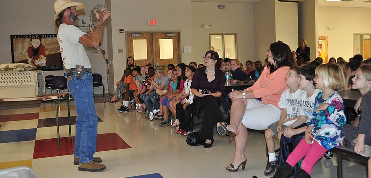 Justin Matthews showed off an iguana to students.