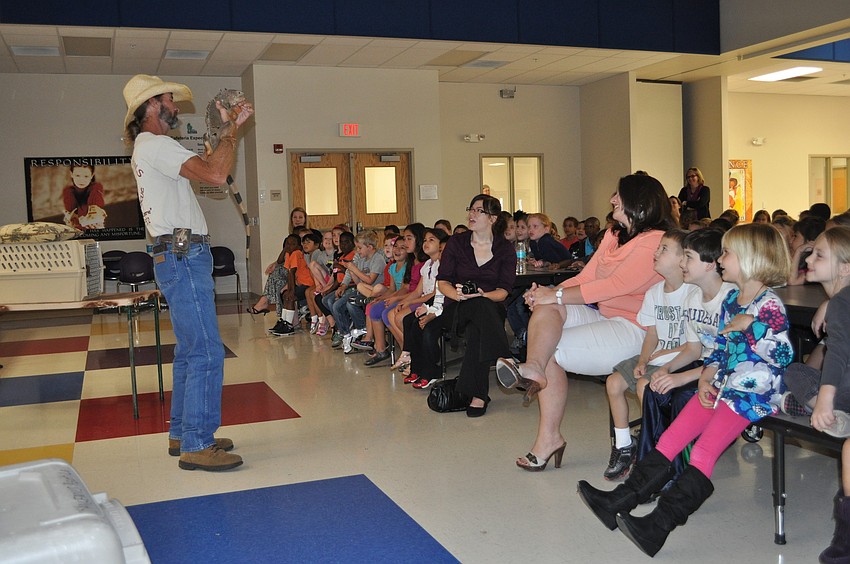 Justin Matthews showed off an iguana to students.