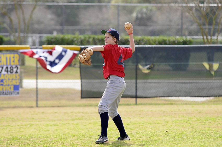 Sam Martin, 11, throws the ball back to a teammate during warm-up drills.